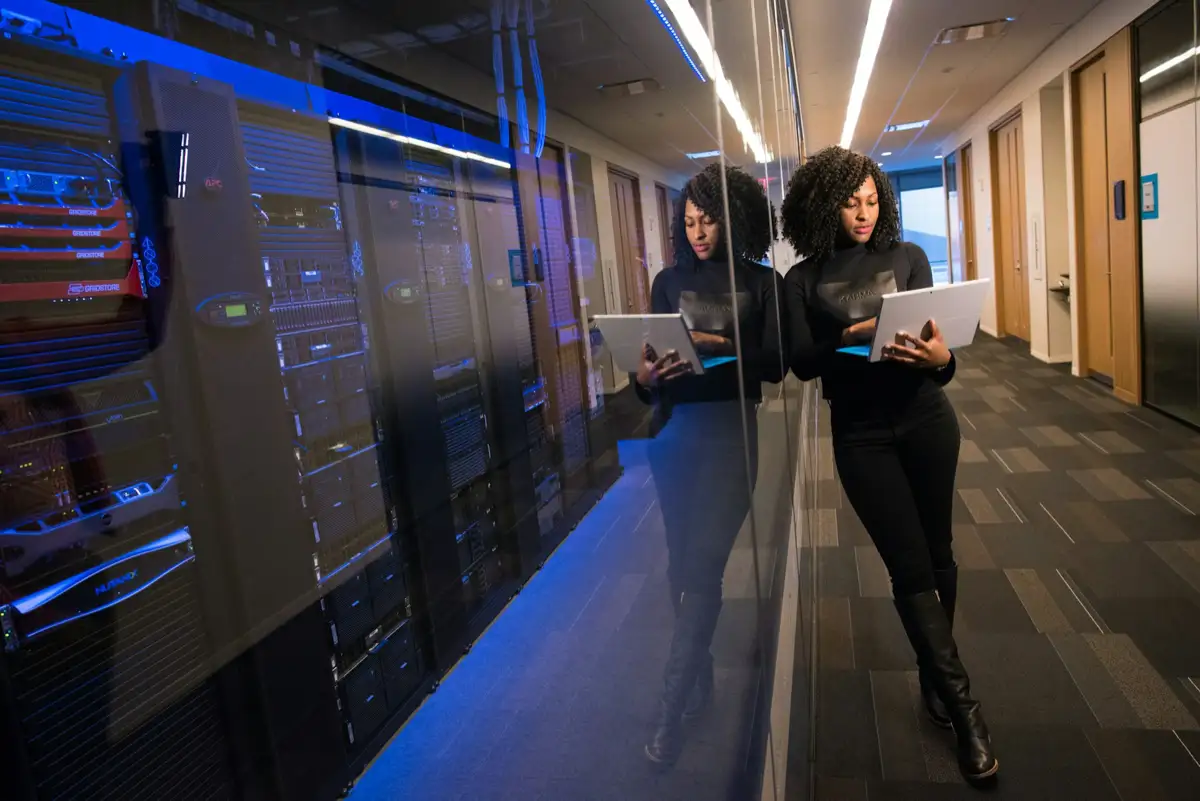 A specialist with a tablet in a server room